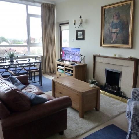 Bright sitting room. Open fireplace. HDTV with Chromecast