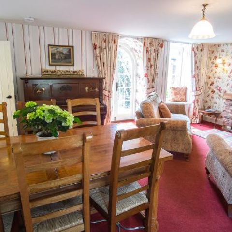 Living/dining room with French windows to garden