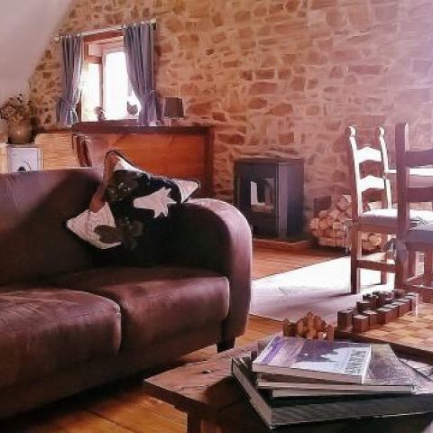 Comfortable lounge furniture, dining table next to double doors leading to the balcony