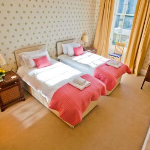 spacious bedroom two single beds