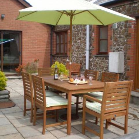 Private patio with seating and charcoal bbq