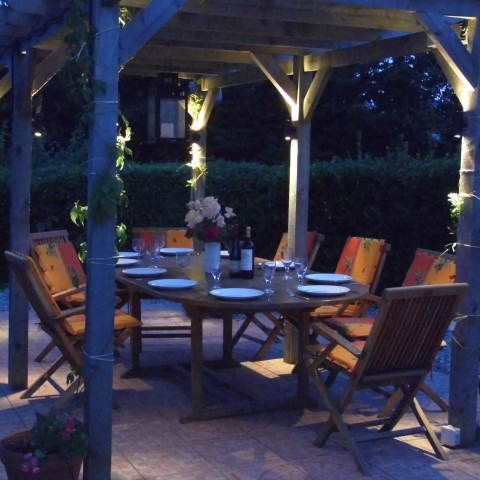 The Pergola, gently lit for evening dining