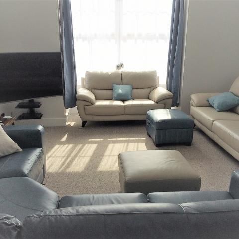 lounge with curved screen tv