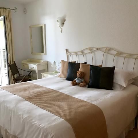 Master bedroom with super-king bed and dressing table, and French doors to terrace