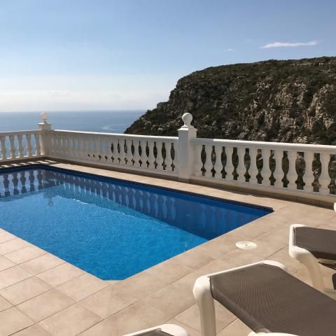 Looking across the terrace and heated pool to the sea